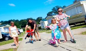 Family walking through holiday caravan area